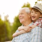 Happy senior man smiling looking away his grandson