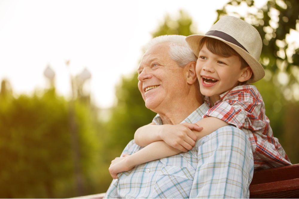 Happy senior man smiling looking away his grandson